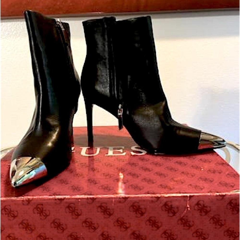 Calvin Klein black ankle bootie, with silver tip.